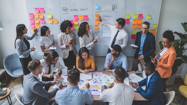 A B2B marketing campaign photo of a group of diverse professionals gathered around a large whiteboard.