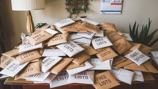 A photo of a large pile of envelopes with the words "Free Email Lists" written on them.