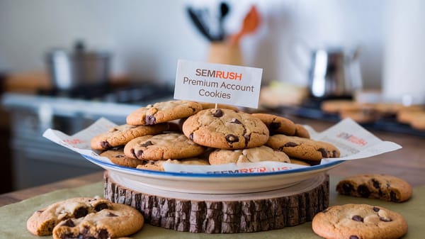 A photo of a plate of freshly baked chocolate chip cookies with the text "Semrush Premium account cookies" on a paper.