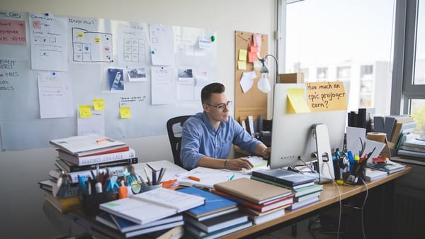 A photo of an Epic project manager working at a desk. 