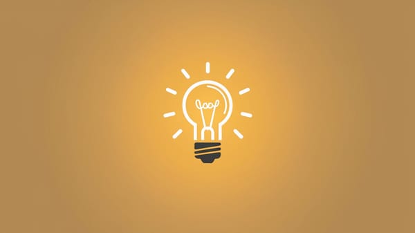  small light bulb icon with a glowing filament inside. The light bulb is centered on a solid color background.