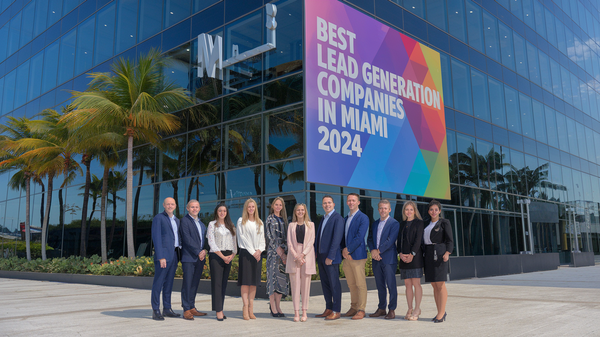 a photo of a group of marketing employees standing outside a building